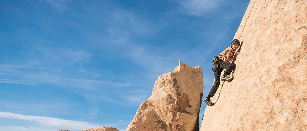 rock climber posing for a picture on a rock